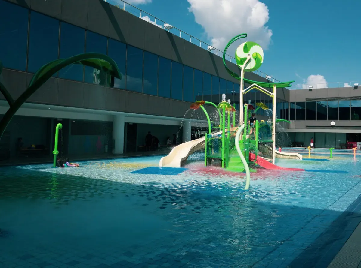 Interactive kiddie pool with water features and splash zones at Our Tampines Hub